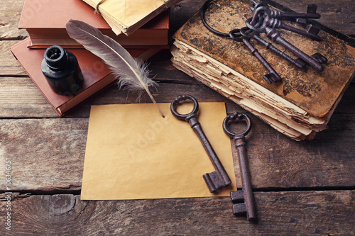 Composition of old books, keys and other things on wooden background, close up