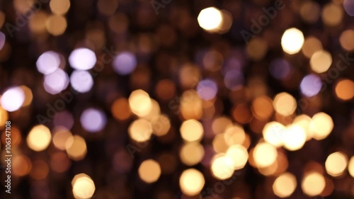 Abstract glittering lights, gold background, a real shot video in the blur