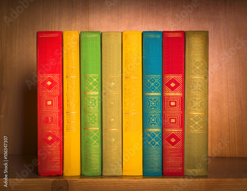 books on shelf, close-up, on wooden background