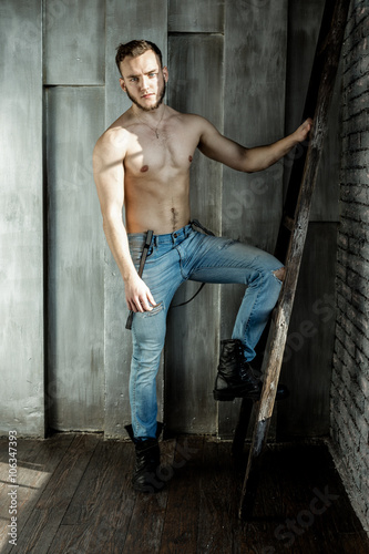 Attractive young Man posing wearing jeans