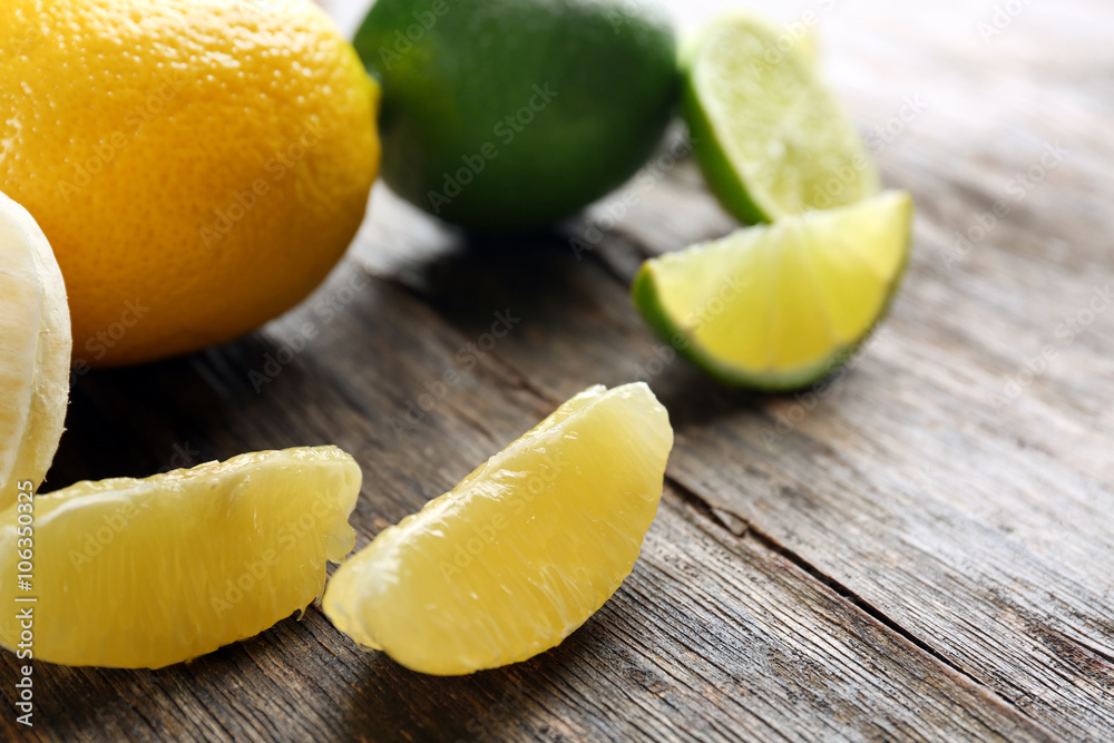 Lemon and lime slices with mint on wooden table Lemon and lime slices with mint on wooden table