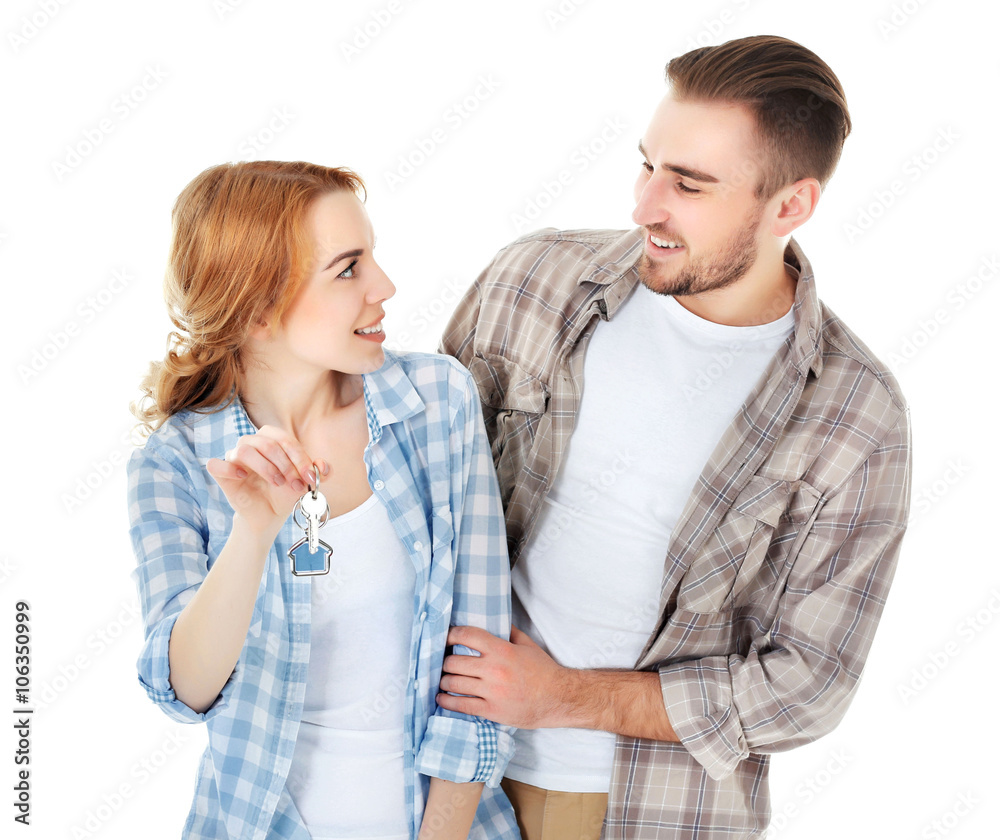 Happy young couple with keys from new house isolated on white Happy young couple with keys from new house isolated on white