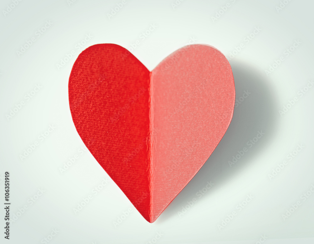 Red paper heart isolated on white background, close up