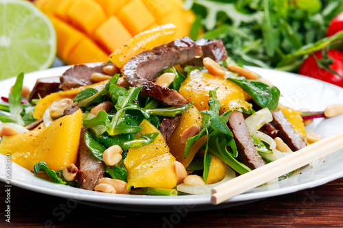 Fresh Tasty Mango, beef salad with vegetables and nuts.