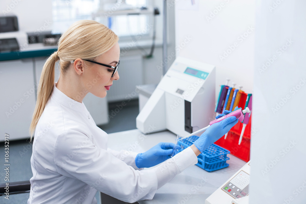 Beautiful female researcher is working in laboratory Beautiful female researcher is working in laboratory