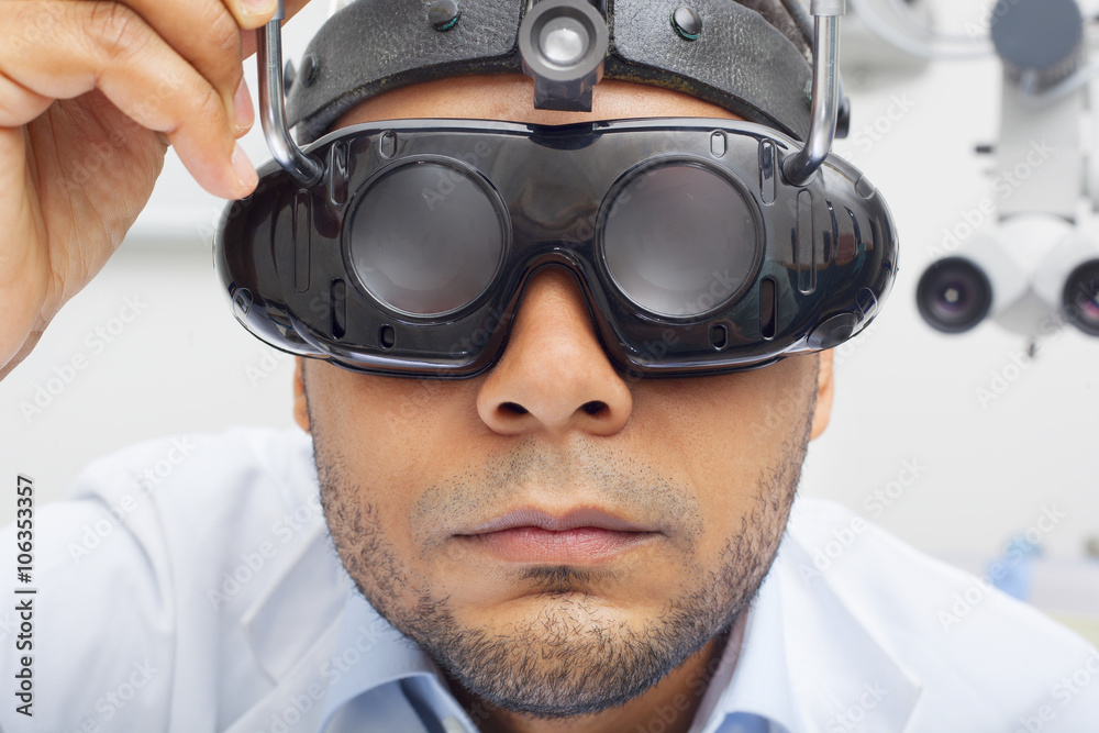 Otolaryngologist Looking Through Magnifying Loupe Otolaryngologist Looking Through Magnifying Loupe