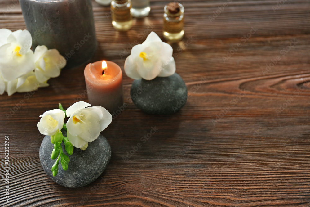 Spa composition with candle, pebbles and aroma oil on wooden background Spa composition with candle, pebbles and aroma oil on wooden background