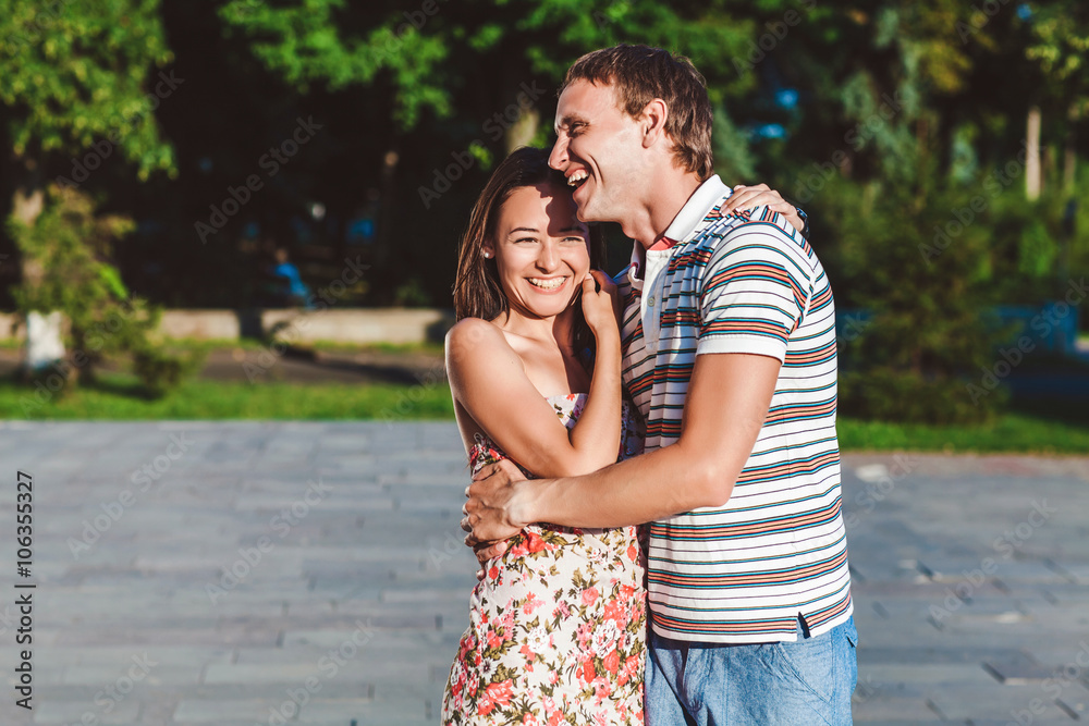 The guy embraces his girlfriend during a walk in the fresh air The guy embraces his girlfriend during a walk in the fresh air