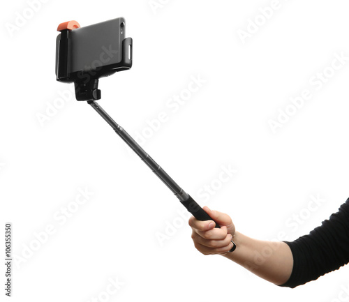Hand holding stick for making photo with mobile phone, isolated on white
