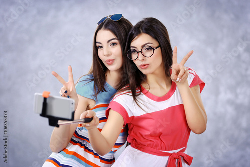 Two teenager girls making p...