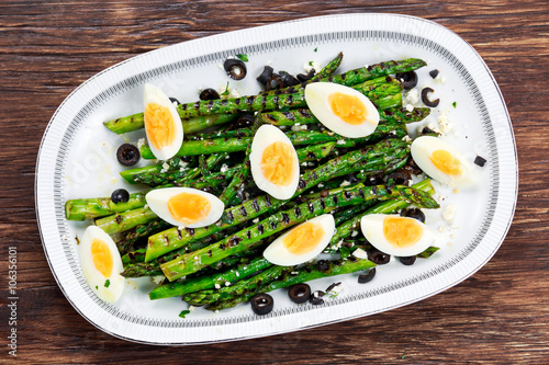 Grilled asparagus salad with feta cheese, olives and eggs