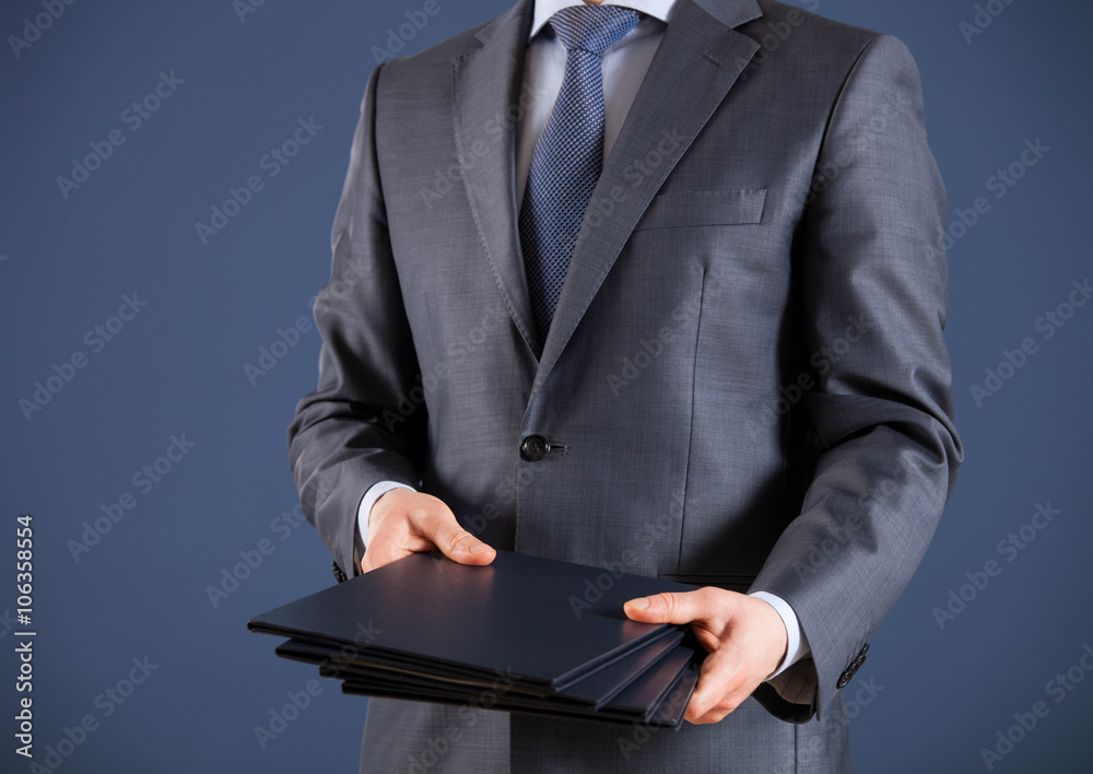 Businessman giving folders to you Businessman giving folders to you