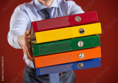 Businessman holding folders