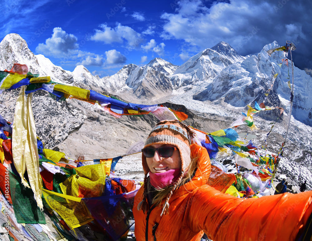 Smiling young woman takes a selfie  on mountain peak  Kala Patthar in Nepal 
A view of Mt. Everest and Khumbu Glacier from the Kala Patthar summit 
