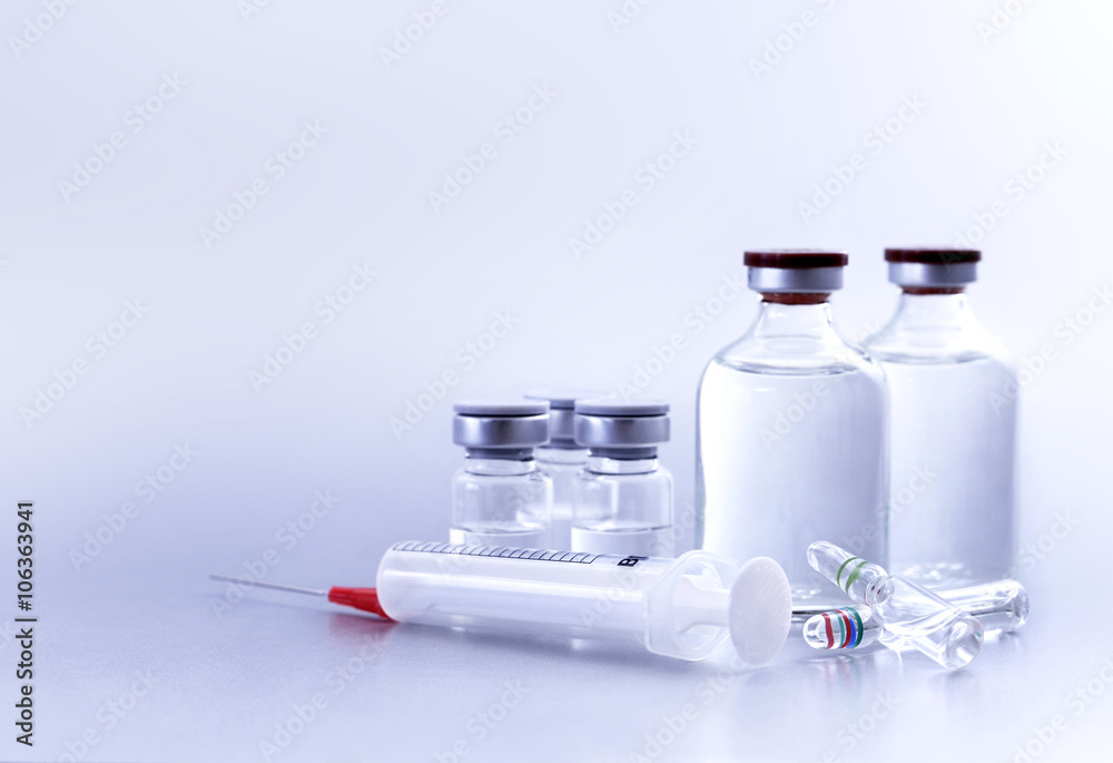 Vials and syringe, studio shot. Medical objects for vaccination. Vials and syringe, studio shot. Medical objects for vaccination.
