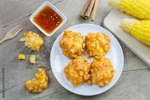 Crispy fried corn ball in a white plate on wooden table, Vegetarian food, Thai food, snacks Thai style.