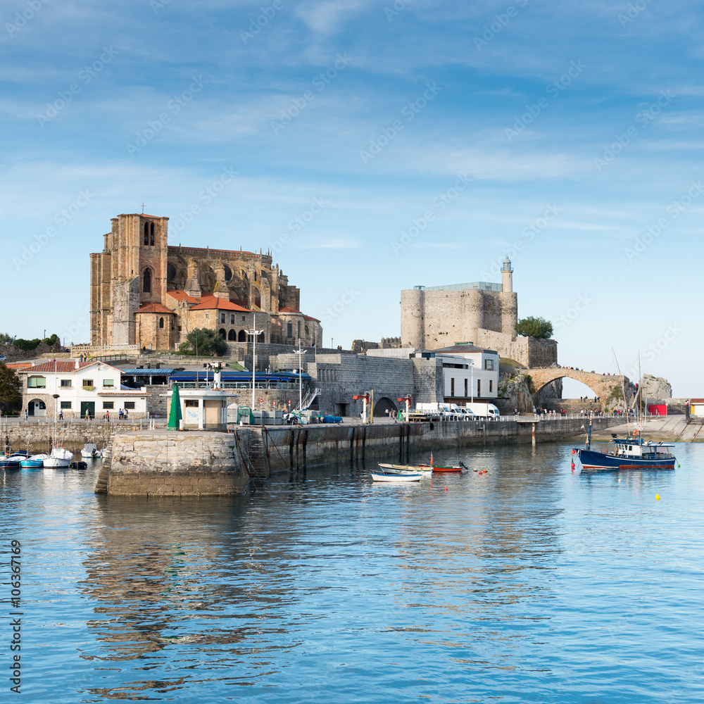 Port of Castro Urdiales. In the background the church of Santa Maria de la Asuncion, the lighthouse of the Castle of Santa Ana and the medieval bridge