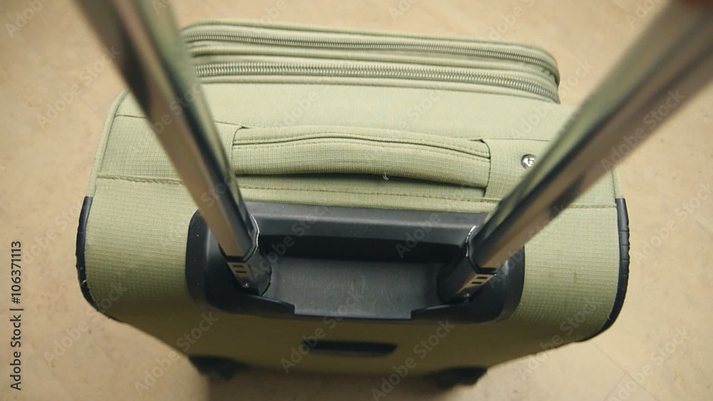Detail zip with hand on a suitcase Detail zip with hand on a suitcase