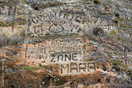 SIGULDA, LATVIA - MARCH 17, 2012: Old  inscriptions in the Gautmanis Cave located on the Gauja River in the National Park of Sigulda, Latvia photo