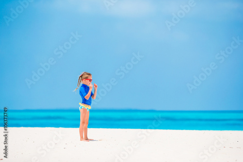 Adorable little girl during beach vacation having fun