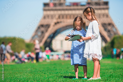 Canvas Print Adorable little girls with map of Paris background the Eiffel tower