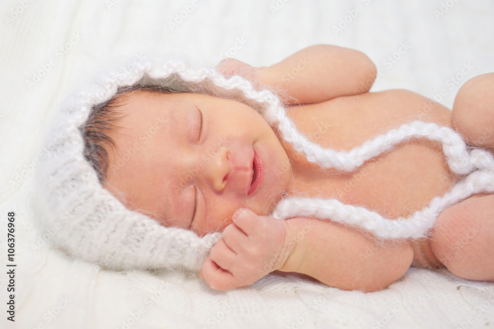 Sleeping smiling newborn baby