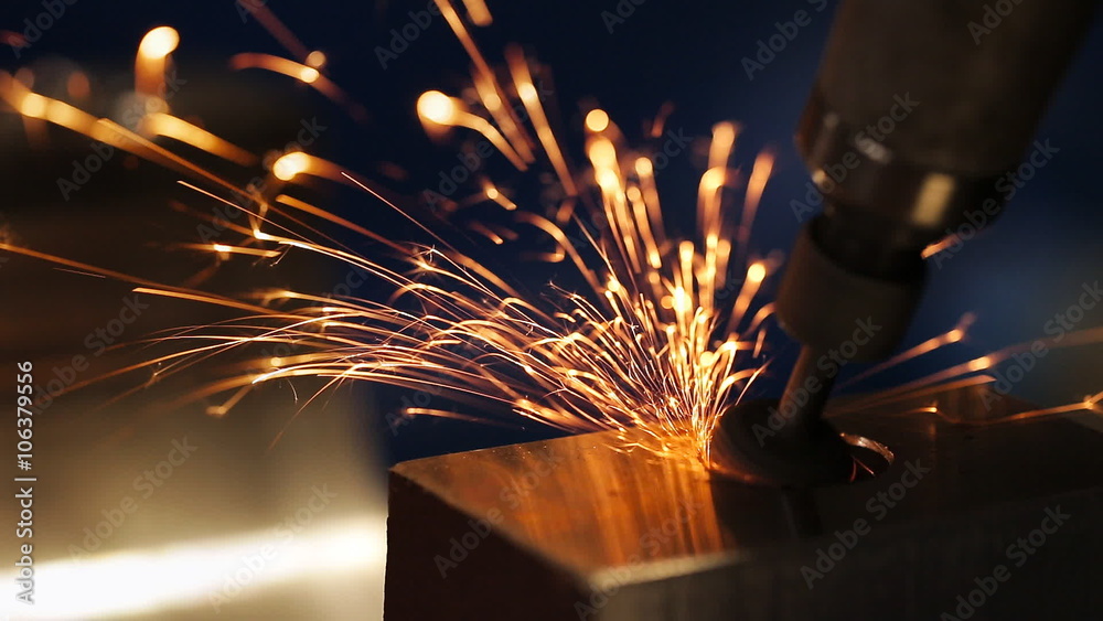 finishing metal working on lathe grinder machine with flying sparks