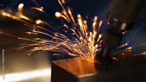 finishing metal working on lathe grinder machine with flying sparks