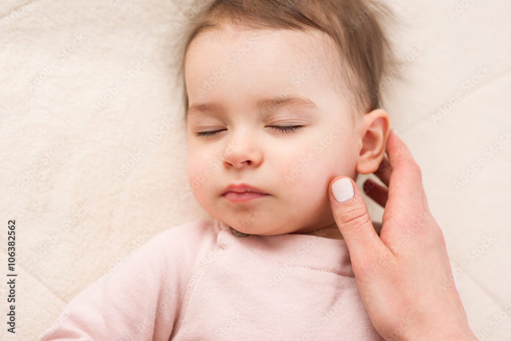 Close-up portrait of sleeping beautiful toddler/baby with touching hand's mother. Close-up portrait of sleeping beautiful toddler/baby with touching hand's mother.
