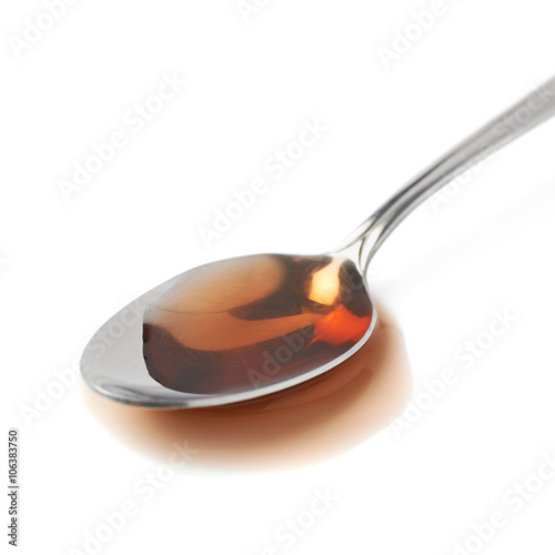 Steel spoon in a puddle of wine vinegar