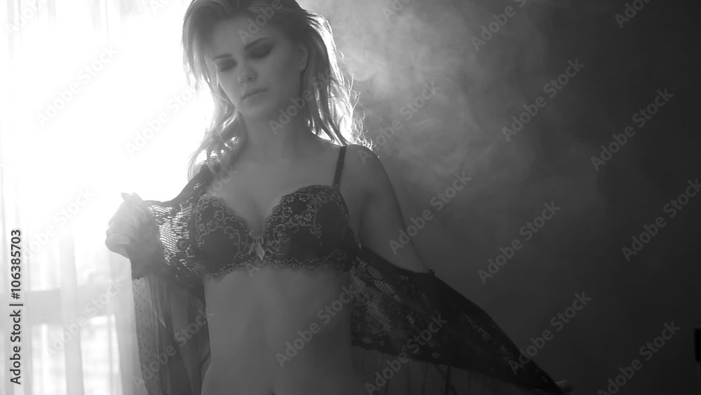 pretty blonde woman taking off her lingerie