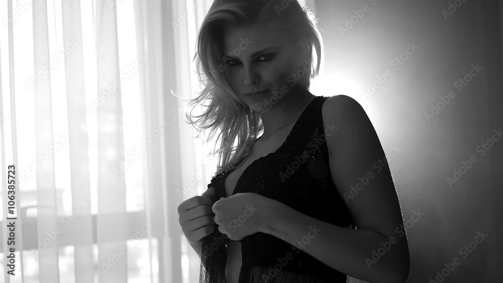 pretty blonde woman taking off her lingerie