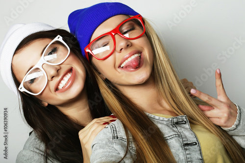 Two teenage girls friends in hipster outfit make selfie 