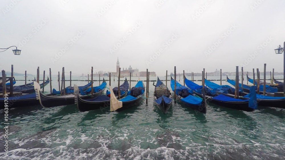 Gondolas in Saint Mark's square (San Marco) with The Church of San Giorgio Maggiore in the background Gondolas in Saint Mark's square (San Marco) with The Church of San Giorgio Maggiore in the background
