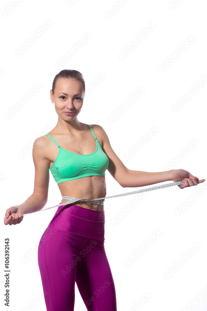 attractive fitness model with measuring tape on a white background attractive fitness model with measuring tape on a white background