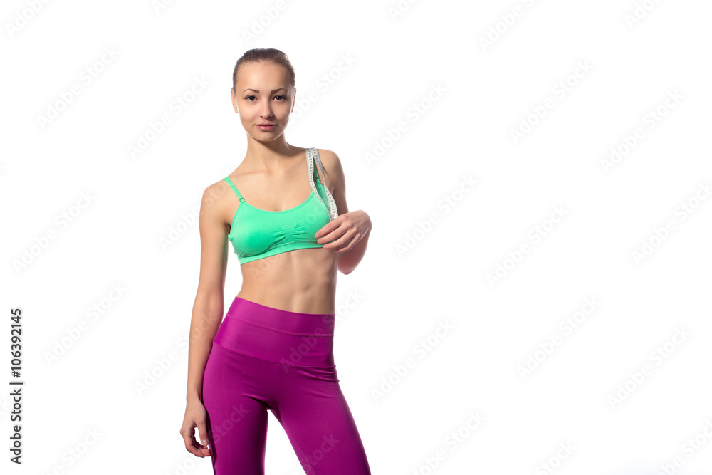 attractive fitness model with measuring tape on a white background attractive fitness model with measuring tape on a white background