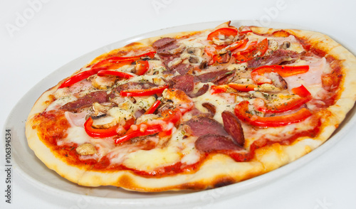Appetizing pizza with mushrooms, salami, vegetables