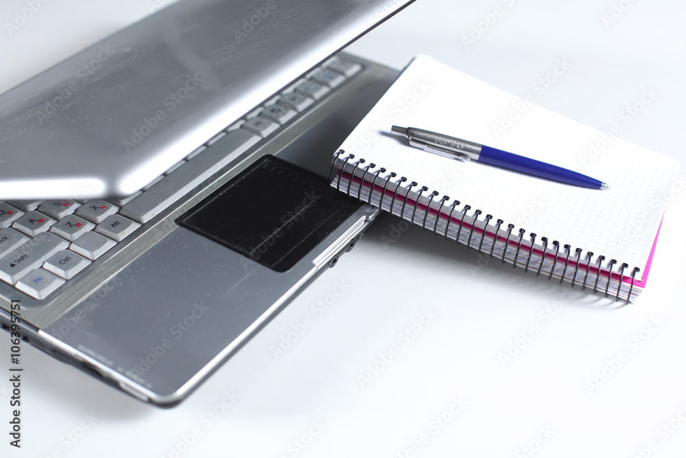 Office table with blank notepad and laptop Office table with blank notepad and laptop
