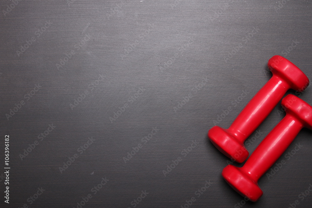 Red dumbbell, fitness concept, top view Red dumbbell, fitness concept, top view