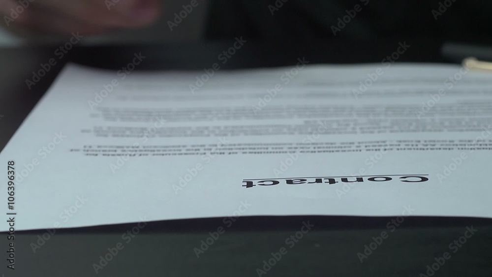 Signing official document with a blue ink pen. Signing official document with a blue ink pen.