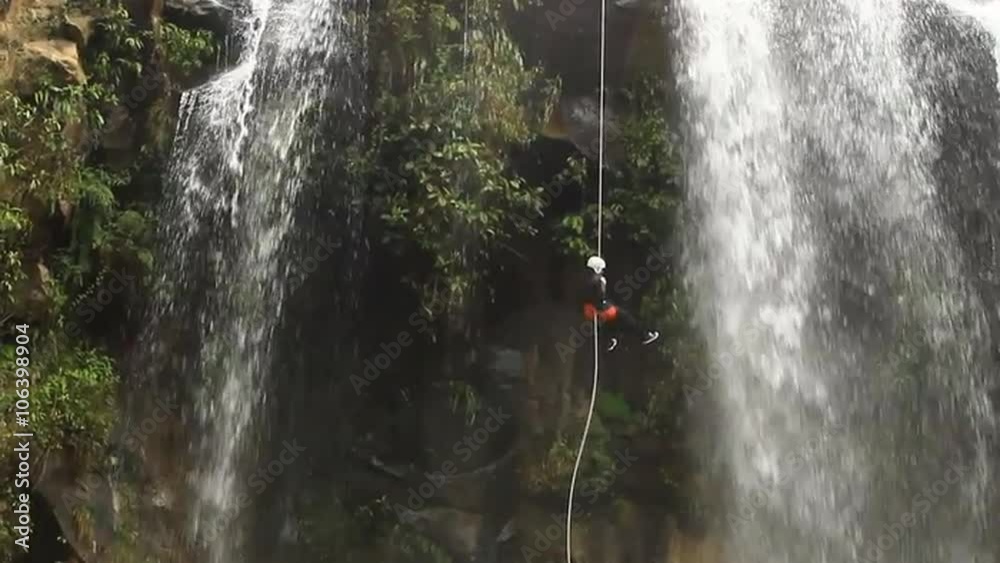 footage of a person rappelling a falls locked down large shot in