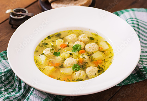Dietary soup with chicken meatballs and stalks of celery