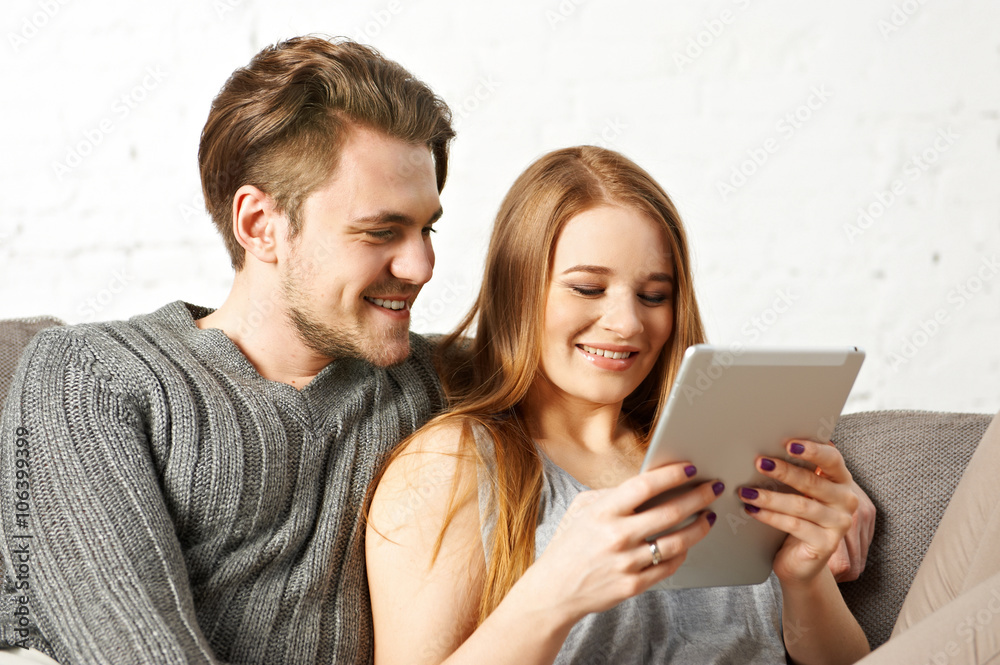Young couple using a tablet computer Young couple using a tablet computer