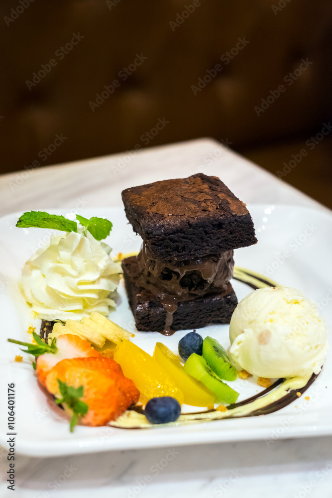 Set of dessert with ice cream, brownies, whip cream and fruits topping