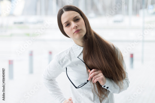 Free Download Confident business woman holding glasses and thinking - GFXLoad