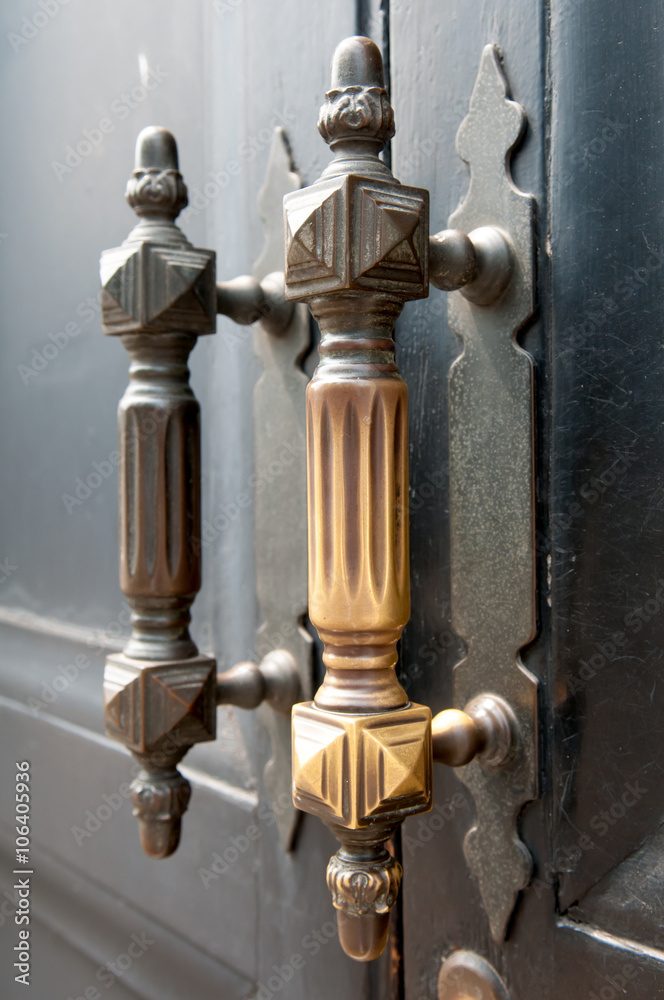 Old doorknobs, doorknockers and handles on ancient doors Old doorknobs, doorknockers and handles on ancient doors