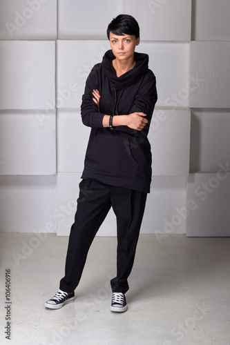 Young black sport wear girl on white cube background