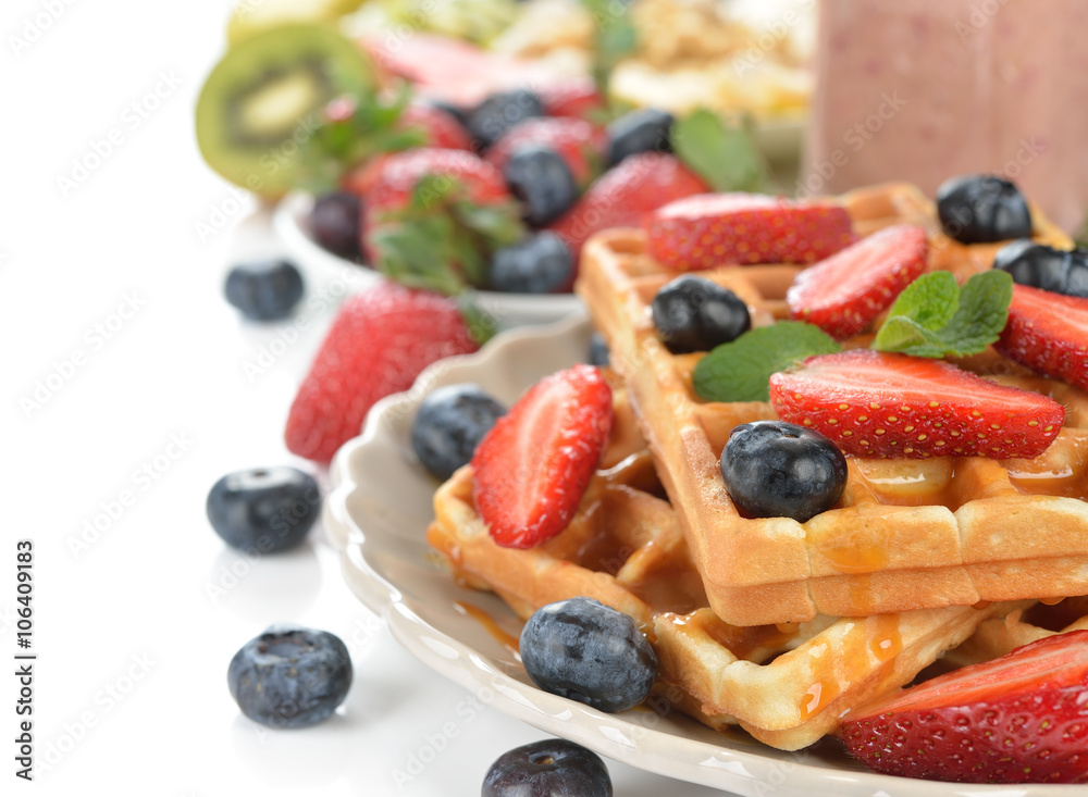 Waffles with berries and caramel sauce