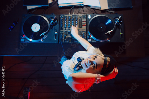 Fotografie Cute dj woman having fun playing music at club party