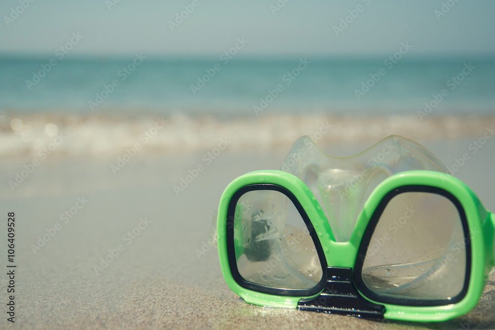 Clear green safety glasses. Goggles for diving on the sand, beach